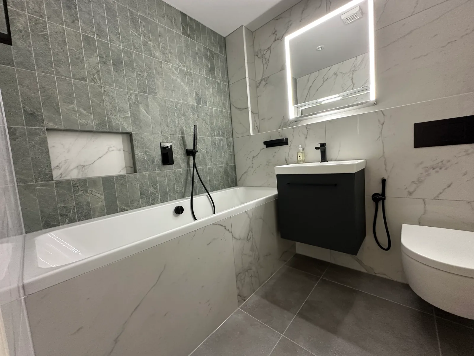 Two complete bathroom renovations in Tuffley, Gloucester 7 Bath And Recessed Niche In A Grey Feature Wall Beside The Vanity In The First Tuffley Bathroom.
