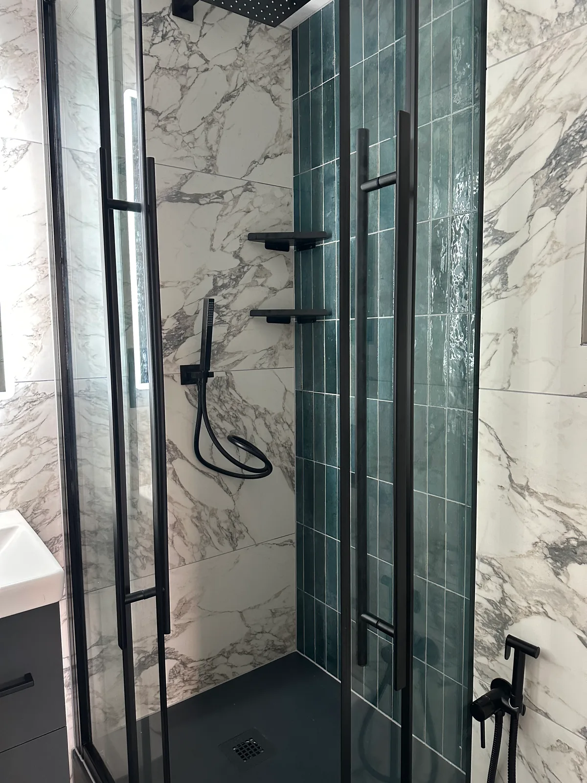 Two complete bathroom renovations in Tuffley, Gloucester 10 Black Shower Fittings Against Green Vertical Tiles Inside The Second Tuffley Shower.